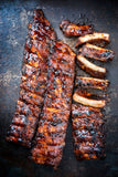 Gooey, smoky BBQ ribs glazed with Boutique Sauces Beef & Rib Sauce. Perfect for slow-cooked, fall-off-the-bone tenderness