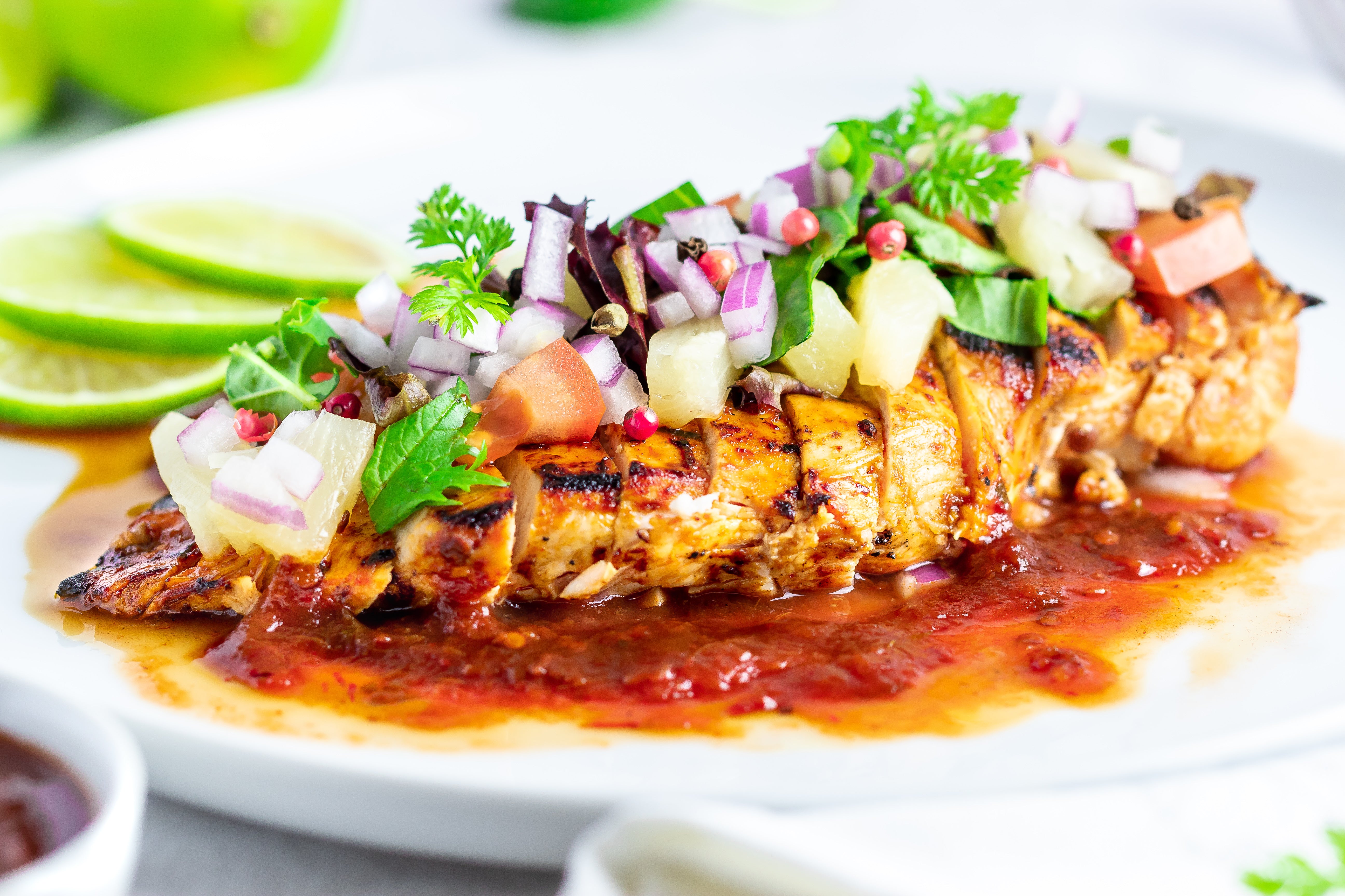 Grilled chicken with smoky chipotle sauce, pineapple, and lime by Boutique Sauces. A spicy and tangy dish topped with fresh salsa, perfect for tacos or BBQ