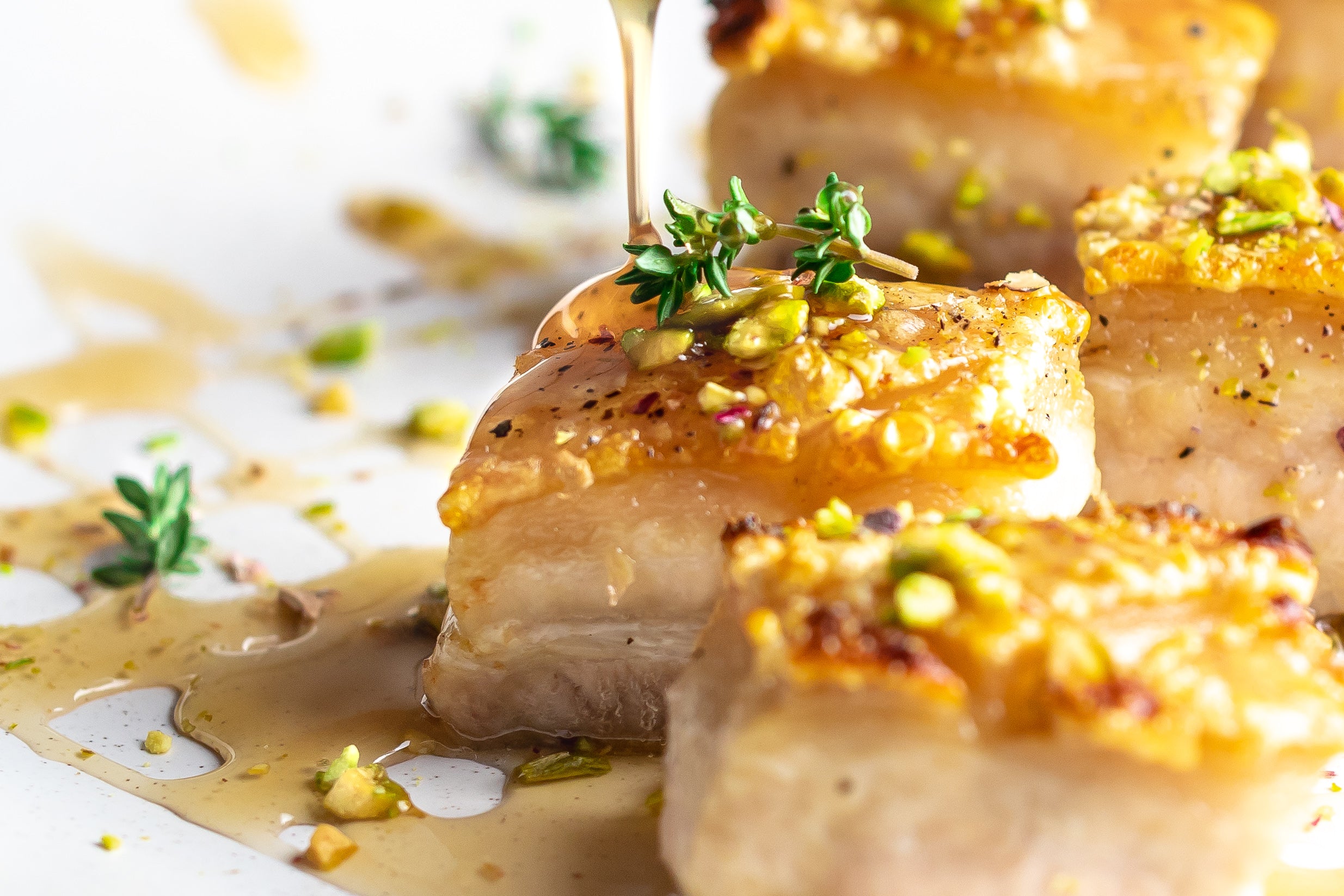 Crispy pork belly drizzled with Orange Star Anise Sauce by Boutique Sauces. A sweet and tangy gourmet sauce with anise & cinnamon, perfect for pork