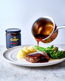 Rich red wine jus poured over a perfectly cooked steak, served with creamy mashed potatoes and broccolini. Boutique Sauces Red Wine Jus for a gourmet finish.
