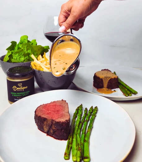 Sliced whole roasted eye fillet steak frites with crispy hand cut frites, asparagus and Boutique Sauces Green Peppercorn Sauce