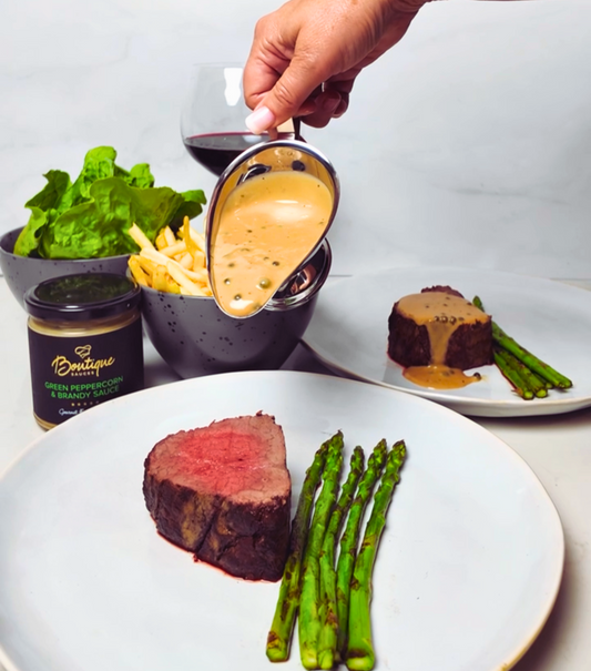 Sliced whole roasted eye fillet steak frites with crispy hand cut frites, asparagus and Boutique Sauces Green Peppercorn Sauce