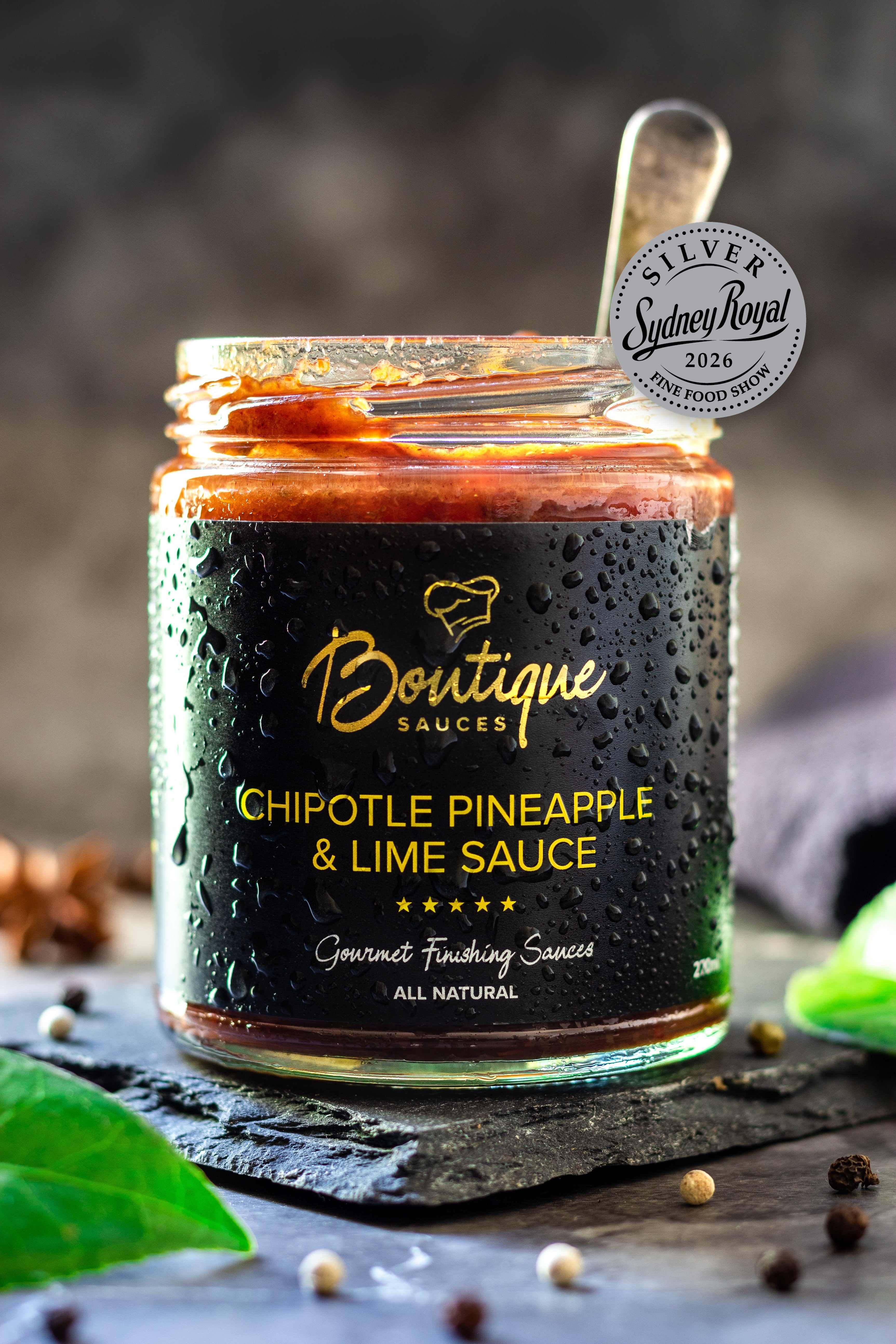 Chipotle Pineapple & Lime Sauce jar by Boutique Sauces with its award medal. Chef-made smoky, tangy sauce for chicken and pork.