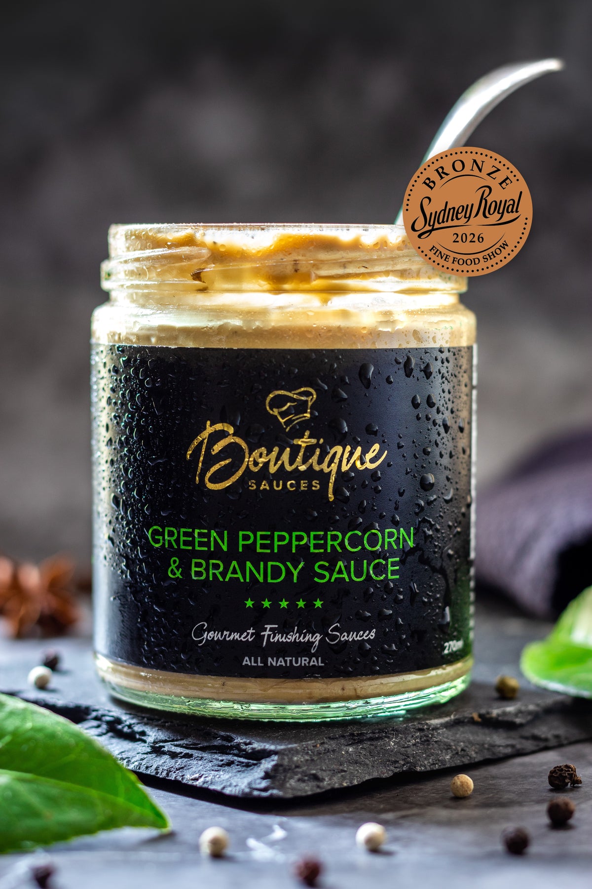 Green Peppercorn & Brandy Sauce jar by Boutique Sauces with its award medal. Chef-made creamy peppercorn sauce for steak.